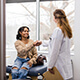 A woman speaking with her provider in a doctor's office.