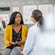 A woman sitting and talking with a doctor.