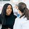Woman Speaking with Female Doctor