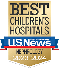A gold badge with a red and blue ribbon holding the U.S. News and World Report logo recognizing best children's hospitals for nephrology.