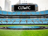 A large stadium with a video board displaying "Charlotte FC".