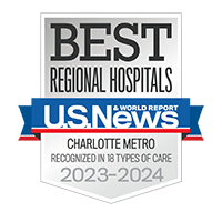 A silver badge with a blue ribbon recognizing the Best Regional Hospitals in the Charlotte Metro area determined by U.S. News and World Report.
