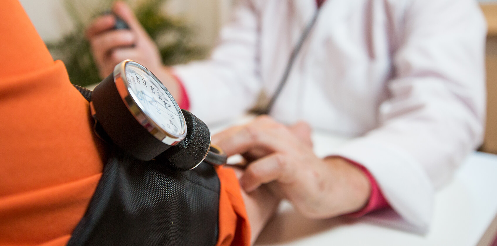 Provider checking a patient blood pressure.