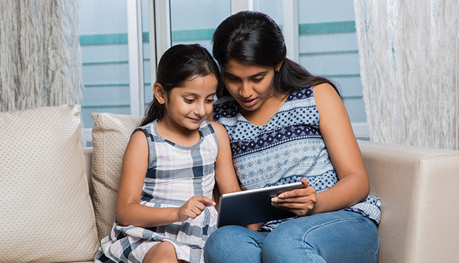 mother and daughter with tablet device