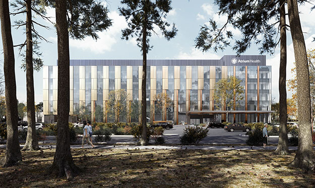 An image of the outside of an Atrium Health facility with trees in the foreground.