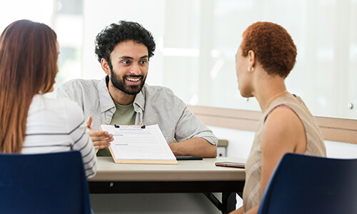 A group works together while looking at a clipboard.
