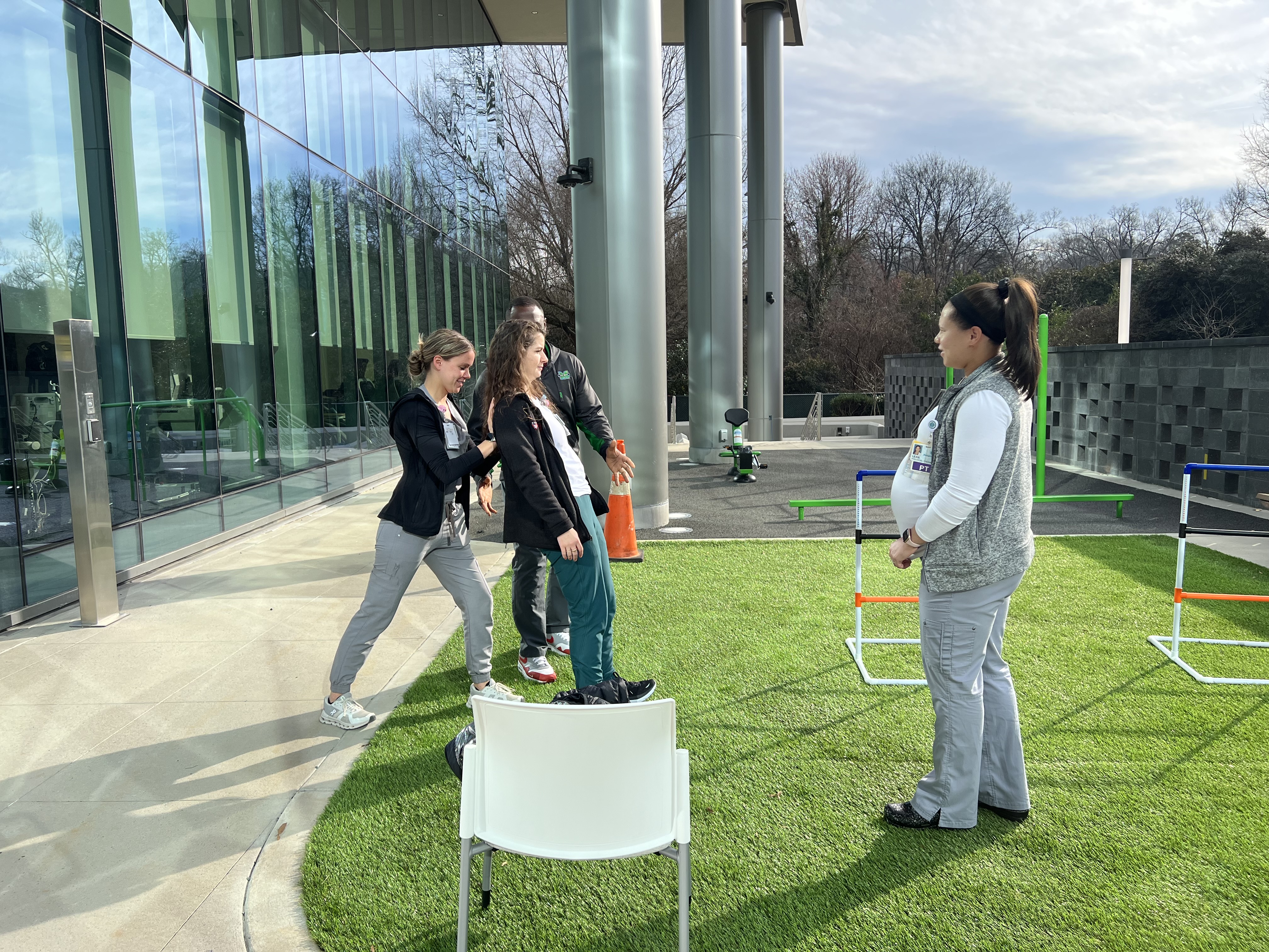 Woman walking, assisted by Neurologic Physical Therapists