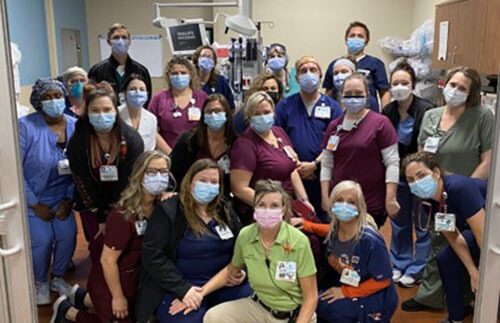 a group photo of doctors and staff in masks.