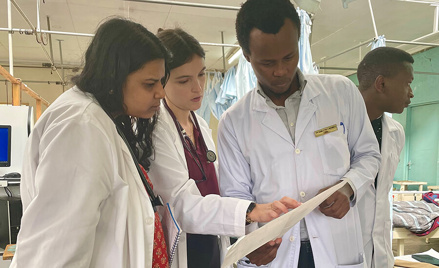 People wearing lab coats looking at paperwork.
