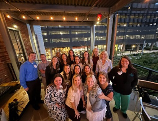 Residents standing together for a group photo at a restaurant.