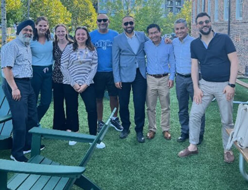 Residents standing and smiling in a group outside.