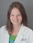 A headshot of a medical professional wearing a lab coat.