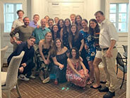 A group of people in dress clothes posed for a group photo.
