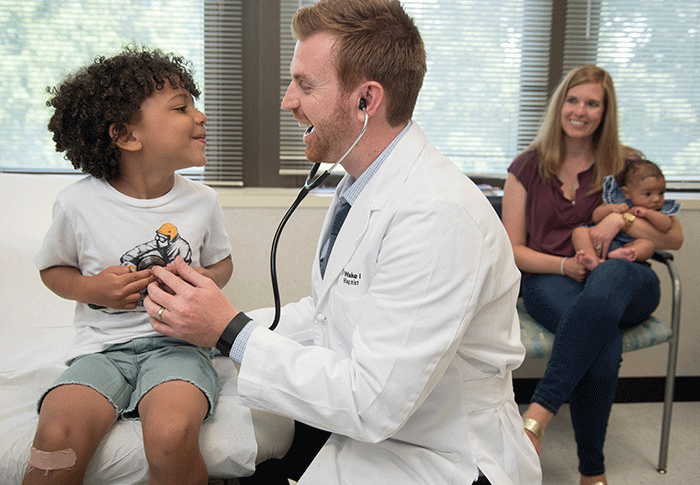 Primary care doctor with young patient