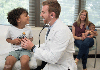 Primary care doctor with young patient