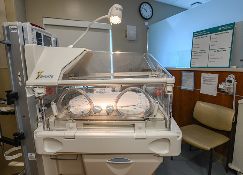 NICU medical equipment resting in the center of a medical suite.