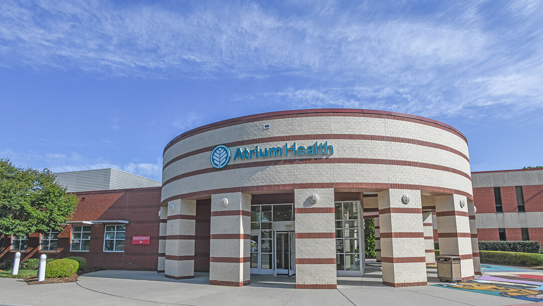 The exterior of a medical office building with a sign that reads "Atrium Health".