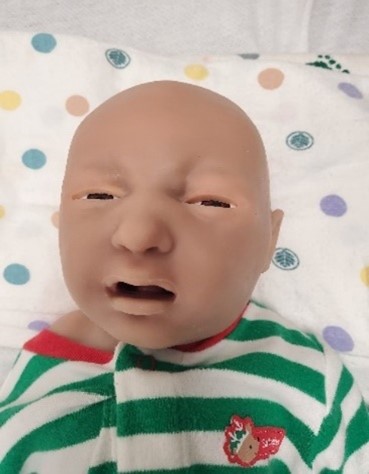 Simulation of baby in green and white shirt; SUPER TORY® S2220 Newborn Simulator 