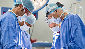 Doctors working together wearing protective equipment.