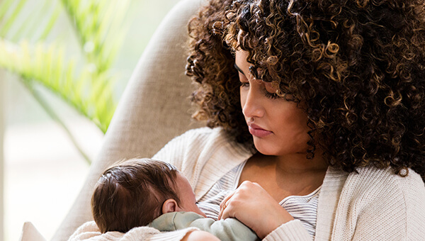Mother holding infant child.