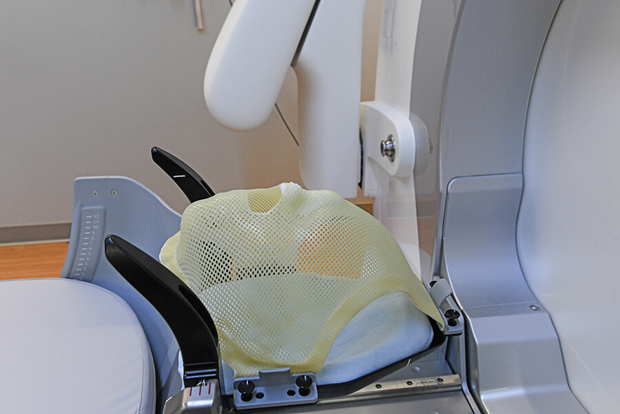 An adult-sized manikin on a piece of medical equipment.