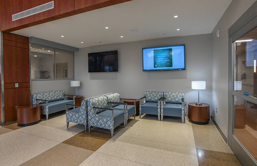 A group of padded chairs in a waiting room of a medical office building.