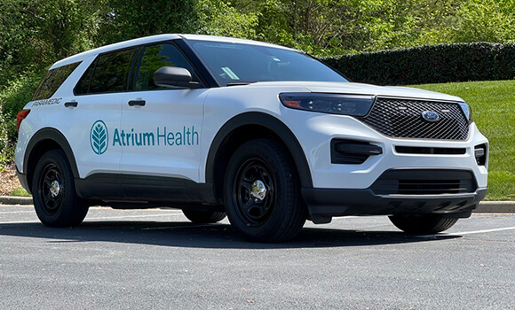 A white SUV with the Atrium Health logo on the side.