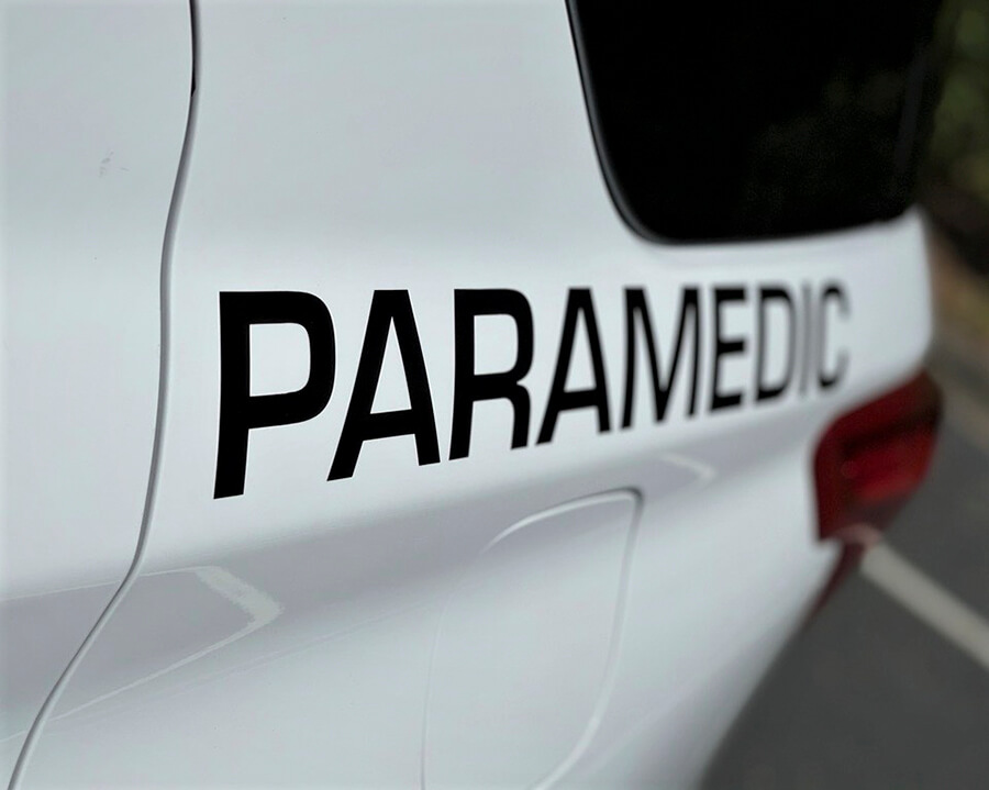 The words "Paramedic" on the side of a white vehicle.