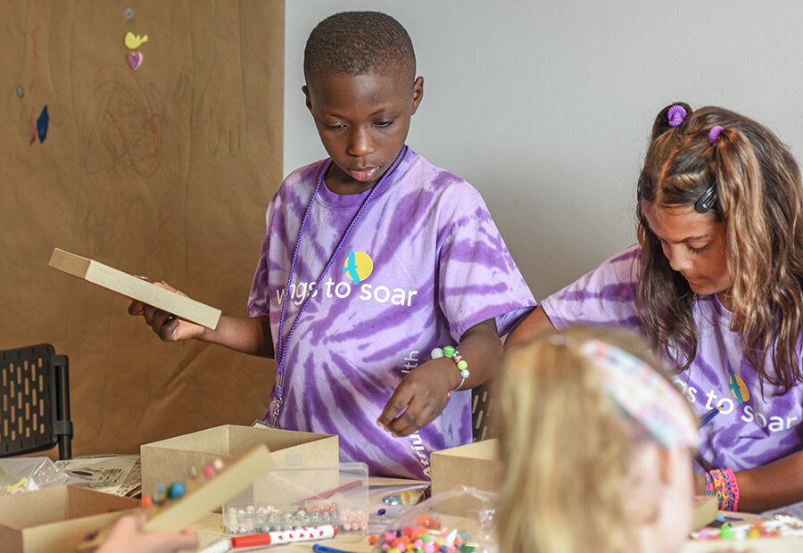 Two young children wearing purple tie-dye t-shirts.