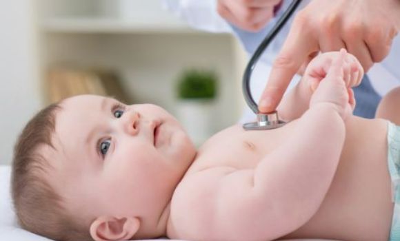 Photo of baby being checked by doctor with stethoscope