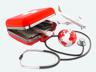 Red medical box open with airplane, red globe and stethoscope.