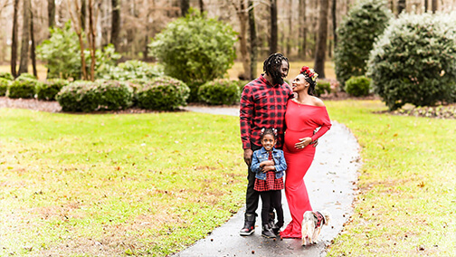Family standing on a sidewalk.