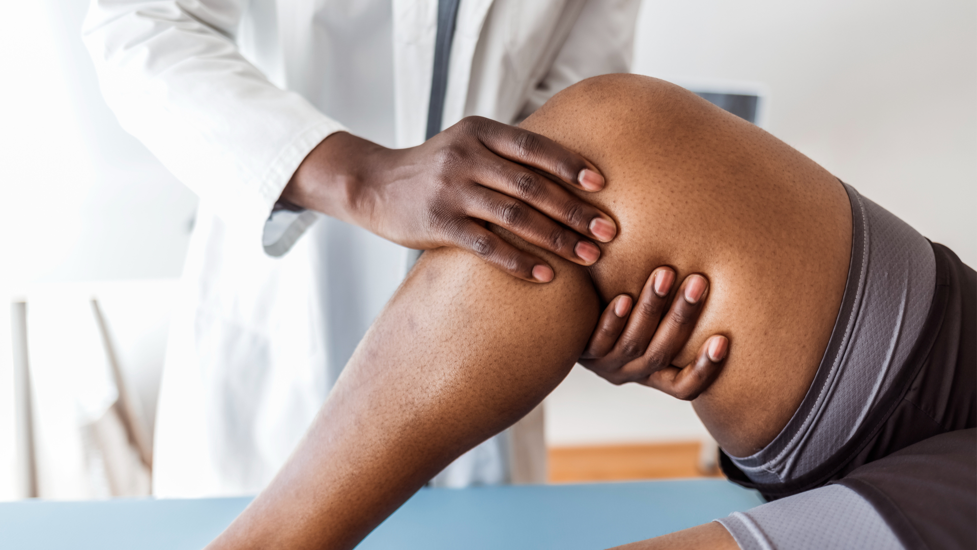 Sports medicine doctor giving patient's leg physical evaluation