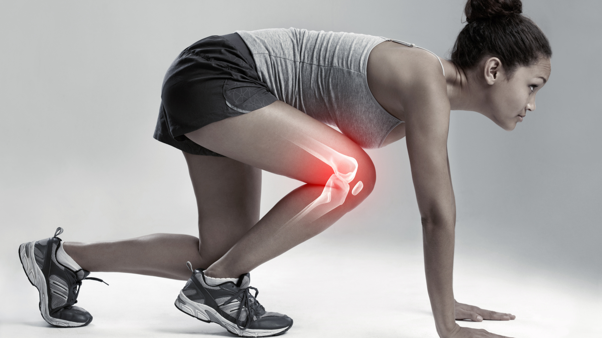 Woman in running position with red coloring on knee to highlight sports medicine specialty for athletes
