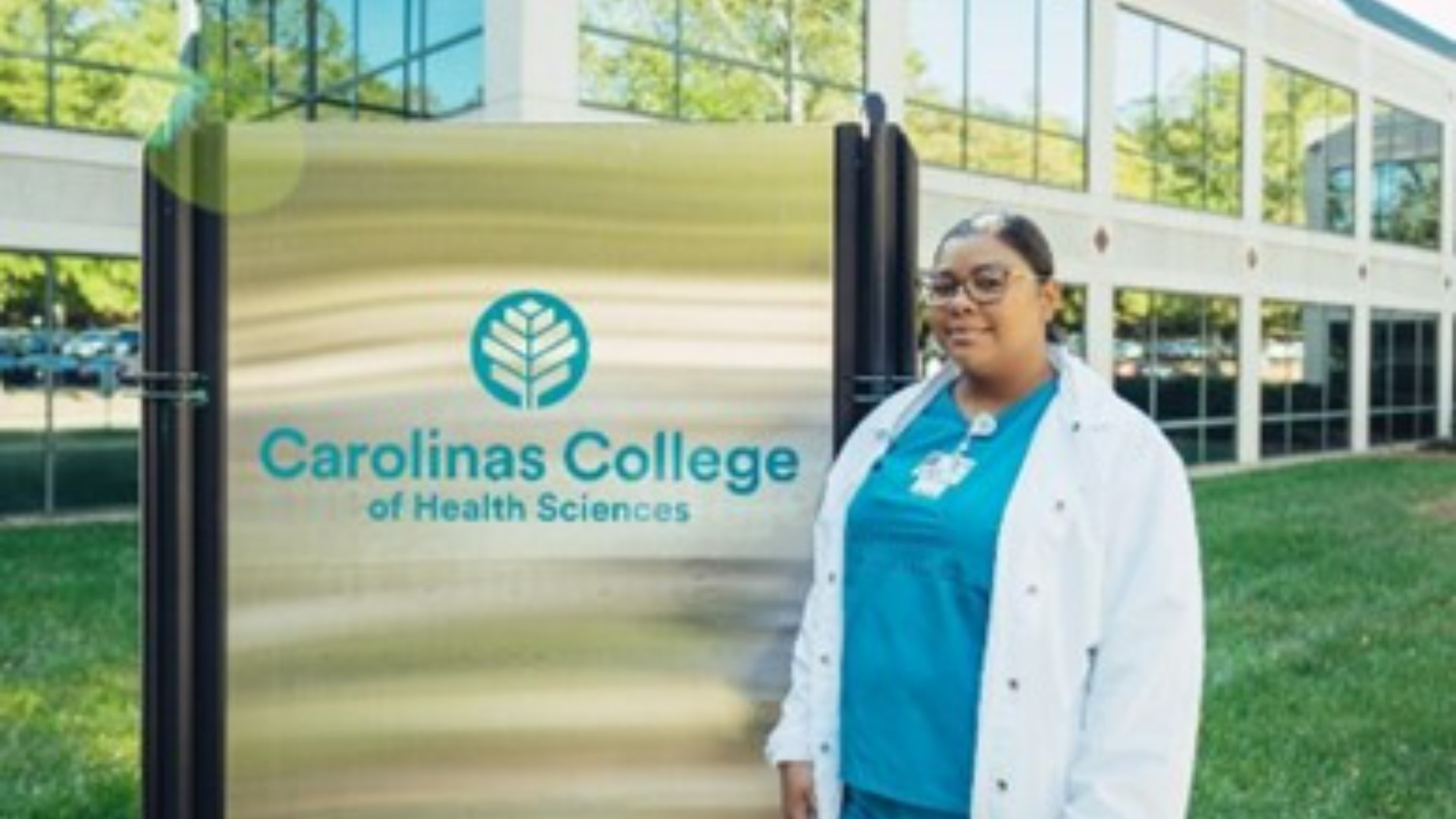 Student standing in front of Carolinas College of Health Sciences