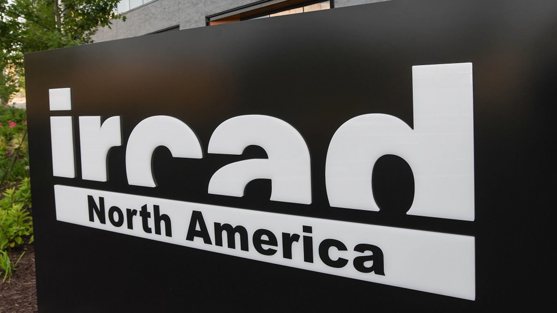 A black outdoor building sign that says "IRCAD North America".