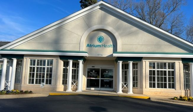 Photo of Atrium Health Musculoskeletal Institute Sports Medicine Huntersville outside with white post columns.