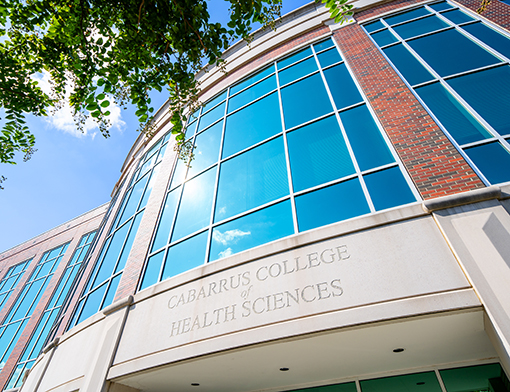 A building with large glass windows that says "Cabarrus College of Health Sciences" above the entrance.