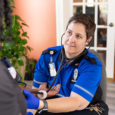 A paramedic providing assistance to someone.
