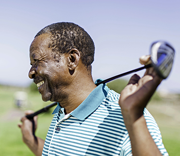 Black male playing golf.
