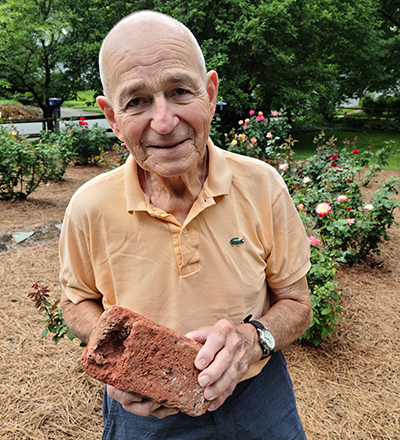 Gary Fleming with an original brick from "Old Main" made by George Black.
