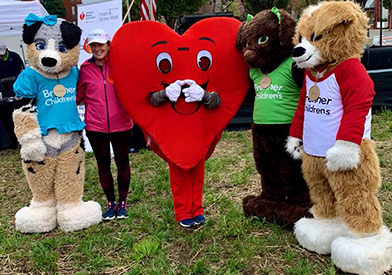 Julie Freischlag, MD with Brenner Children's mascots. 