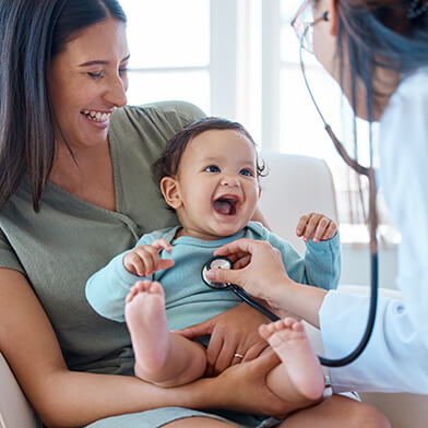 An infant receiving care while being help by their mother.