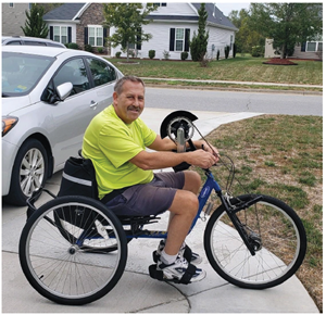 Bruce Lambert, a trauma survivor, rides his bike.