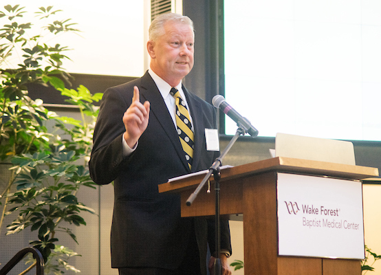 Doug Hartman speaking at podium