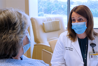 Dr. Davis with patient in mask.