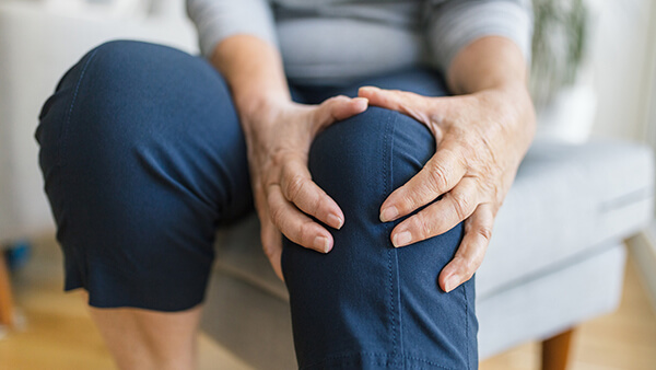 A person holding their knee.