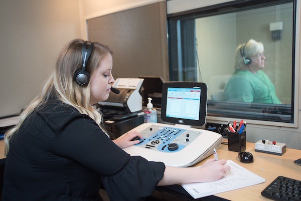 Performing hearing test with patient