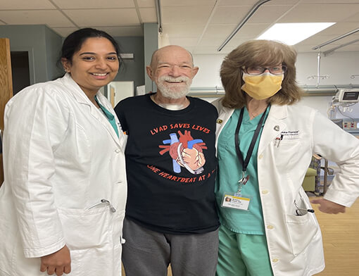 A man and two women in medical scrubs standing together.