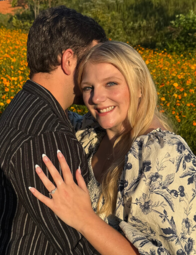 Natalee Hurst and her partner smiling and hugging each other.